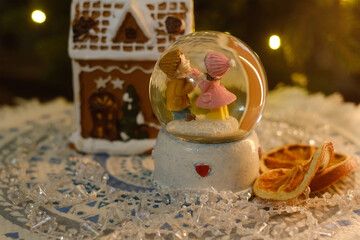 Christmas decorations, cozy home decor. Cute snow globe and gingerbread house.