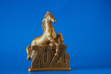 The figure of a horse and the date 2026 on a blue background. A holiday date.