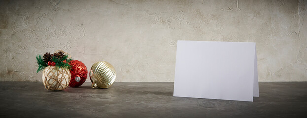 A festive Christmas scene featuring classic wooden nutcracker figurines, decorative ornaments, and a blank greeting card on a textured background, perfect for holiday promotions.