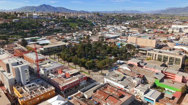 Establishing panoramic aerial view of the Plaza de Armas in Ovalle on a sunny day in the Limar&iacute; Valley, northern Chile.