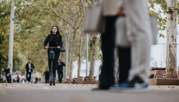 A focused woman on an electric scooter travels down a tree-lined urban street as pedestrians move in the background, capturing everyday city life and active commuting in a calm outdoor scene. - Powered by Adobe