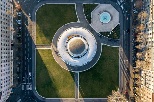 Aerial view of the Art Pavilion's circular structure and the adjacent fountain create a mesmerizing geometric dance with the surrounding greenery, Zagreb, Croatia.