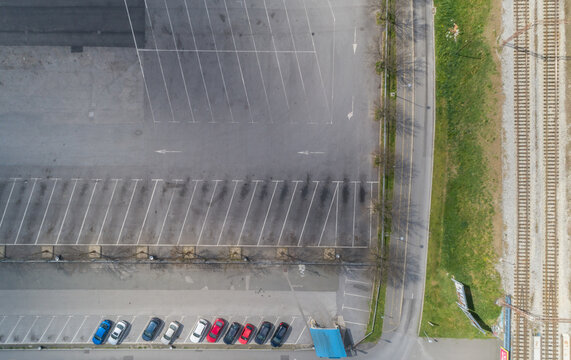 Aerial view of empty parking lot with few cars near the railway tracks, Zagreb, Croatia.