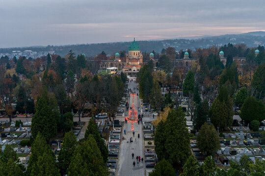 Aerial view of Mirogoj Cemetery's grand architecture and orderly rows of graves beneath a soft, diffused sky, Zagreb, Croatia.