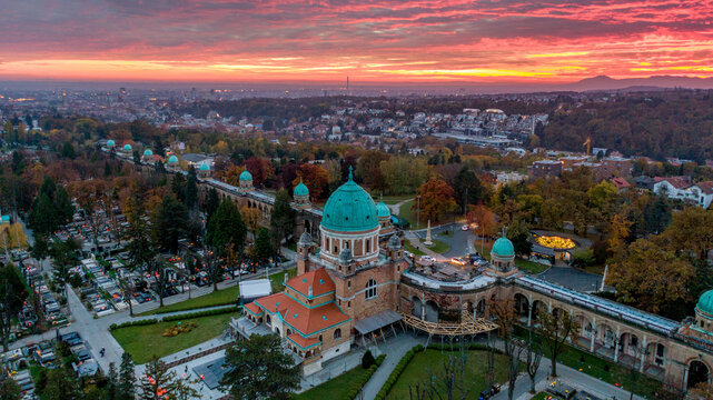 Aerial view of Mirogoj Cemetery's elegant domes and arcades glow under the vibrant hues of the setting sun, Zagreb, Croatia.