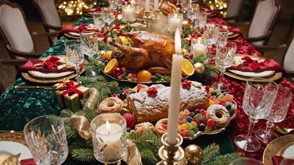 Overhead view of Thanksgiving dinner table with roasted turkey centerpiece. Elegant holiday setup featuring candles fruits and decorations for festive family meal video footage video footage