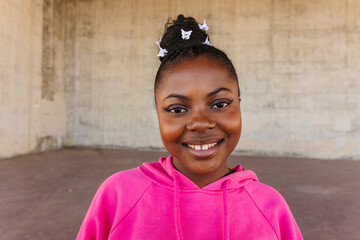 Happy young woman smiling wearing pink hoodie