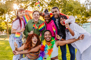 Diverse group celebrating lgbtq plus pride with rainbow flags