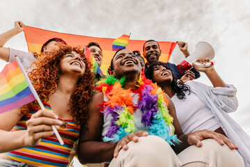 Diverse joyful friends celebrating lgbtq pride parade outdoors