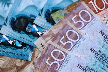Obraz premium New Zealand dollar money bills in big amount on table close up. Rich life concept in New Zealand. Business and economy