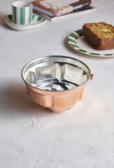 Classic pot displayed on a clean surface, highlighting its metallic texture and iconic coffee-brewing design.