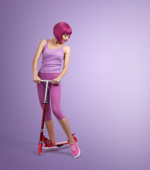Young woman in vibrant pink and purple activewear standing with a red scooter against a pastel lavender background, expressing playful style, modern youth lifestyle, and fun urban aesthetics.