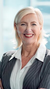 Mature woman, face and smile at office with pride, laugh and actuary career at insurance company. Person, happy and consultant in portrait, job and arms crossed at risk management agency in Germany