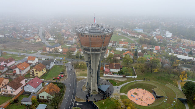 Aerial view of the iconic Vukovar Water Tower, a symbol of resilience amidst a serene landscape, stands tall against the misty horizon, Vukovar, Vukovar-Srijem County, Croatia.