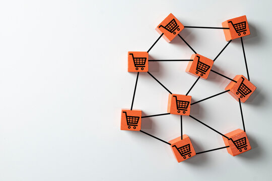 E-commerce and online shopping network concept. Connected orange blocks with cart icons representing digital retail strategy,global market distribution,and supply chain logistics on white background.