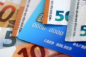 Euro money bills banknotes and credit card for cashless payments. Concept of banking service in European Union countries