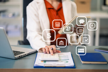 Business woman calculates financials with graph paper on the table on the cost of home office in the evening.