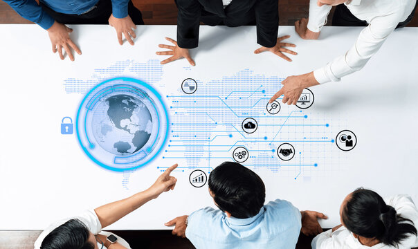 A diverse team engages in a strategic business meeting focusing on data security and global connections, showcasing innovative ideas and technology in a modern office setting. Trope