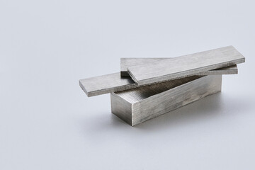 High quality close up image of stainless steel metal bars and flat sections with smooth industrial texture, suitable for construction, engineering, manufacturing, and industrial design concepts.