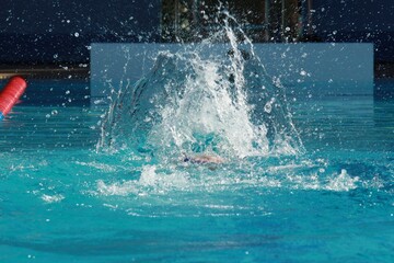 Swimming competition in the swimming pool, close up of water splashes