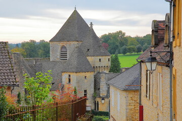 The village Saint Genies, Dordogne, France, with medieval houses (with slate roofs), the church of Our Lady of the Assumption and the castle