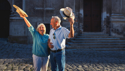 Happy senior couple walkig through the city.