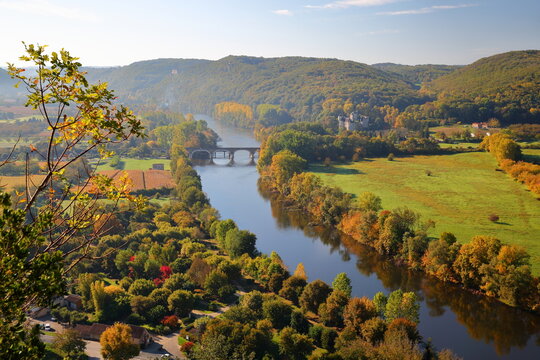 The countryside and the river Dordogne viewed from the top of the medieval village Beynac et Cazenac, Dordogne, France, with autumn colors and Feyrac Castle on the right