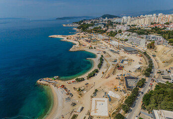 Aerial view of the coastline showing construction with the blue sea contrasting with the earth tones of the land, Split, Split-Dalmatia County, Croatia.