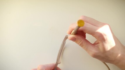 Unrecognizable optician using a tiny screwdriver to tighten a loose screw on the hinge of a pair of eyeglasses, showcasing detailed craftsmanship and vision care maintenance in an optical workshop