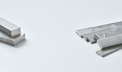 High quality close up image of stainless steel metal bars and flat sections with smooth industrial texture, suitable for construction, engineering, manufacturing, and industrial design concepts.