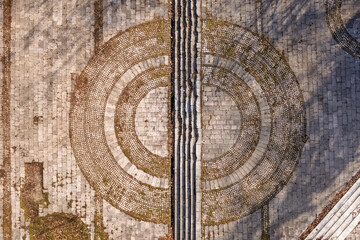 Aerial view of the stark, geometric patterns of a stone plaza with concentric circles bisected by a linear pathway, Sarajevo, Federation of Bosnia and Herzegovina, Bosnia and Herzegovina.