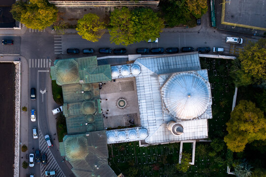 Aerial view of the Gazi Husrev-beg Mosque's domes gleaming under the autumn sun, surrounded by trees and city streets, Sarajevo, Federation of Bosnia and Herzegovina, Bosnia and Herzegovina.