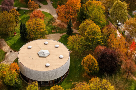 Aerial view of the round building nestled among vibrant autumn trees, showcasing nature's colorful palette, Sarajevo, Federation of Bosnia and Herzegovina, Bosnia and Herzegovina.