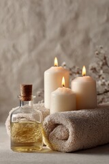 Serene Spa Still Life - Lit Candles, Oil Bottle, Rolled Towel, Soft Lighting.
