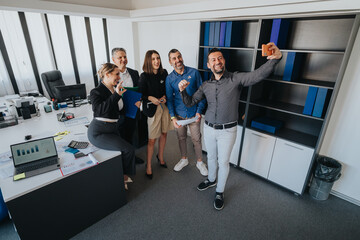 Group of colleagues expressing teamwork and enthusiasm in a modern office environment, embracing collaboration and camaraderie.