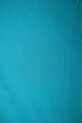 Detailed texture of blue woven fabric with a slight vignette effect.