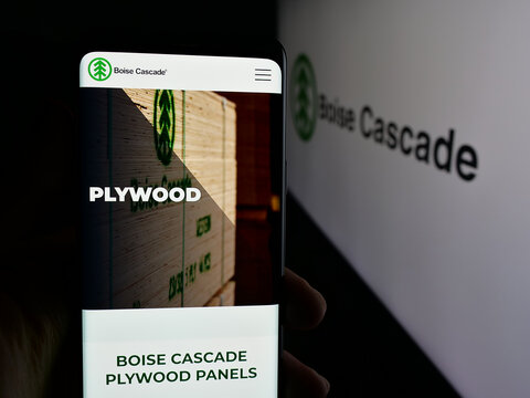 Stuttgart, Germany - 11-12-2025: Person holding cellphone with webpage of US wood company Boise Cascade Company on screen in front of logo. Focus on center of phone display.