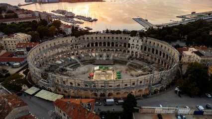 Pula, Croatia - 17 November 2025: Aerial view of the ancient Roman amphitheater, a stone sentinel against the soft, golden light of a late afternoon sun.