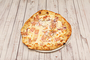 The carbonara pizza reinterprets classic pasta with egg, crispy guanciale, black pepper, and pecorino cheese on a béchamel sauce