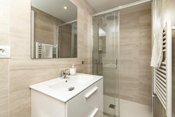 Minimalist bathroom renovation with a wall-hung toilet and niche storage system, using large-format tiles to minimize grout lines.