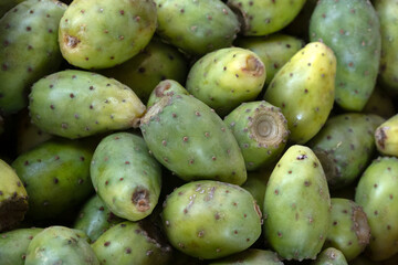 Closeup of fresh green Prickly pear cactus fruit on a stall at a food market