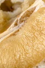 thick peel and juicy flesh of ripe grapefruit, sweet fresh grapefruit peeled from the yellow thick peel