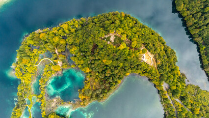 Aerial Drone View of Plitvice Lakes National Park in Croatia. Pristine turquoise waters, untouched wild forest, cascading waterfalls, and breathtaking natural beauty captured from above