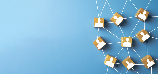 Business network and teamwork concept. Wooden blocks with person icon connected by lines, idea for human resources,social connection, organization structure,community on a blue background.,copyspace.
