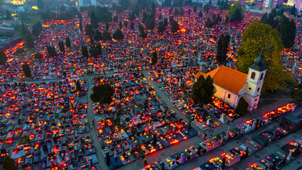 Aerial view of countless candles flicker across the cemetery, casting a warm glow against the cool night air near the church, Osijek, Osijek-Baranja County, Croatia.