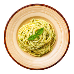 Pesto pasta long noodles with green sauce, basil garnish, on tan dish