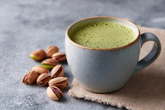 Textured close-up of creamy pistachio milk in a rustic cup - Powered by Adobe