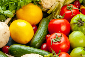 Healthy Mix of Ripe Red Tomatoes, Green Cucumbers, and Bright Yellow Lemons