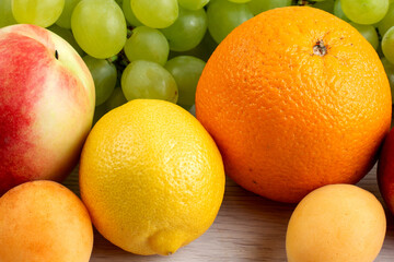 A Colorful Assortment of Fresh Ripe Fruits Including Grapes, Orange, and Peach