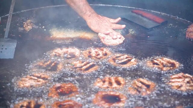 Slow motion shot of cooking of traditional Pakistani street food chappal kabab